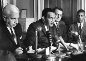 The Rev. L. F. Griffin (center) reads a statement on Prince Edward. Henry L. Marsh, III is on the far right. 1963 photo. Gov. Albertis Harrison far left.